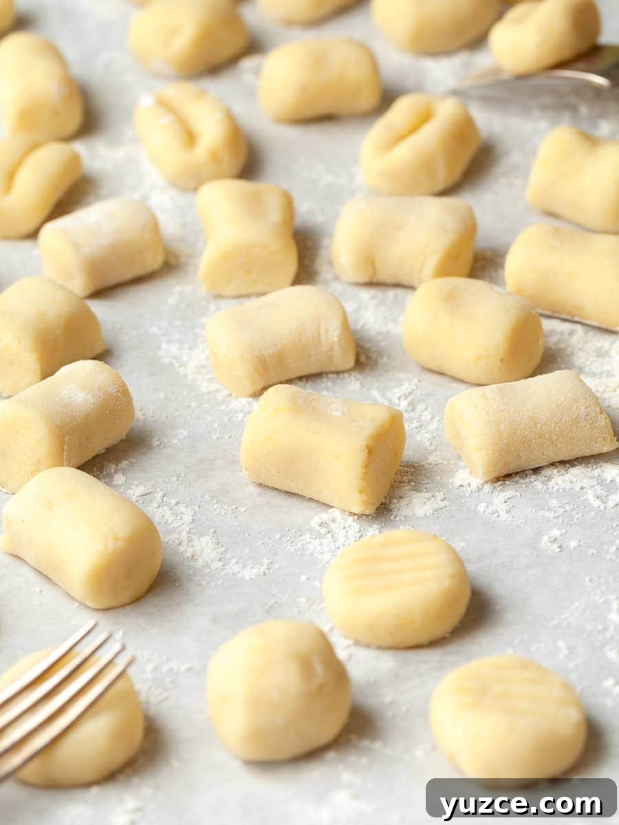 Homemade Gluten-Free Gnocchi Recipe for Tender Pillowy Dumplings 4 gluten free gnocchi on floured parchment paper