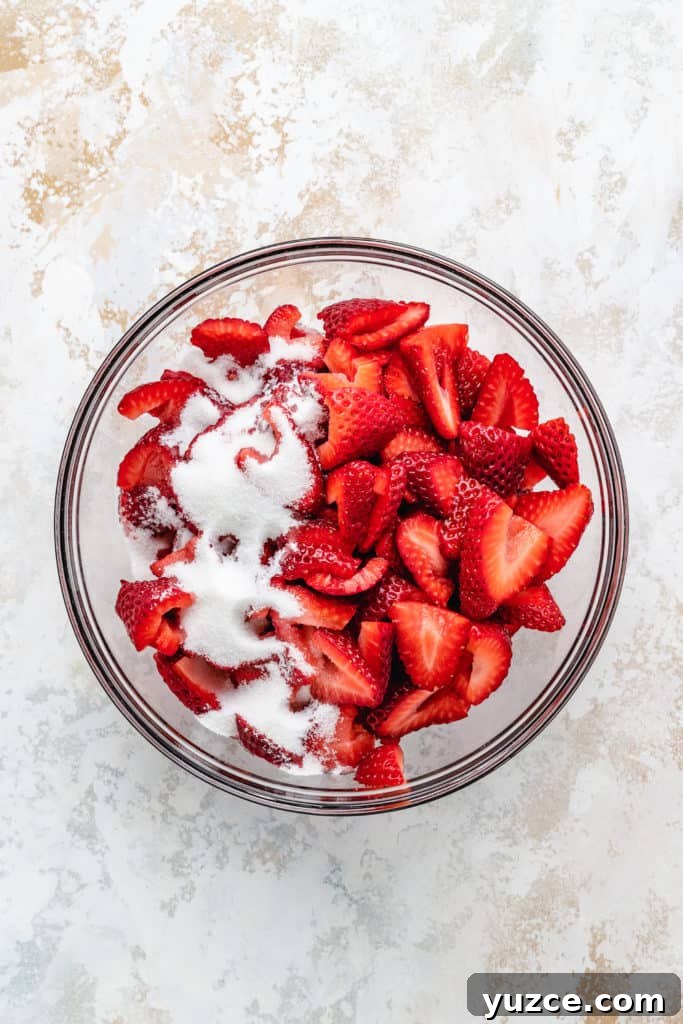 Classic Strawberry Shortcake Recipe with Fresh Strawberries and Cream 3 Strawberries and sugar in a bowl.