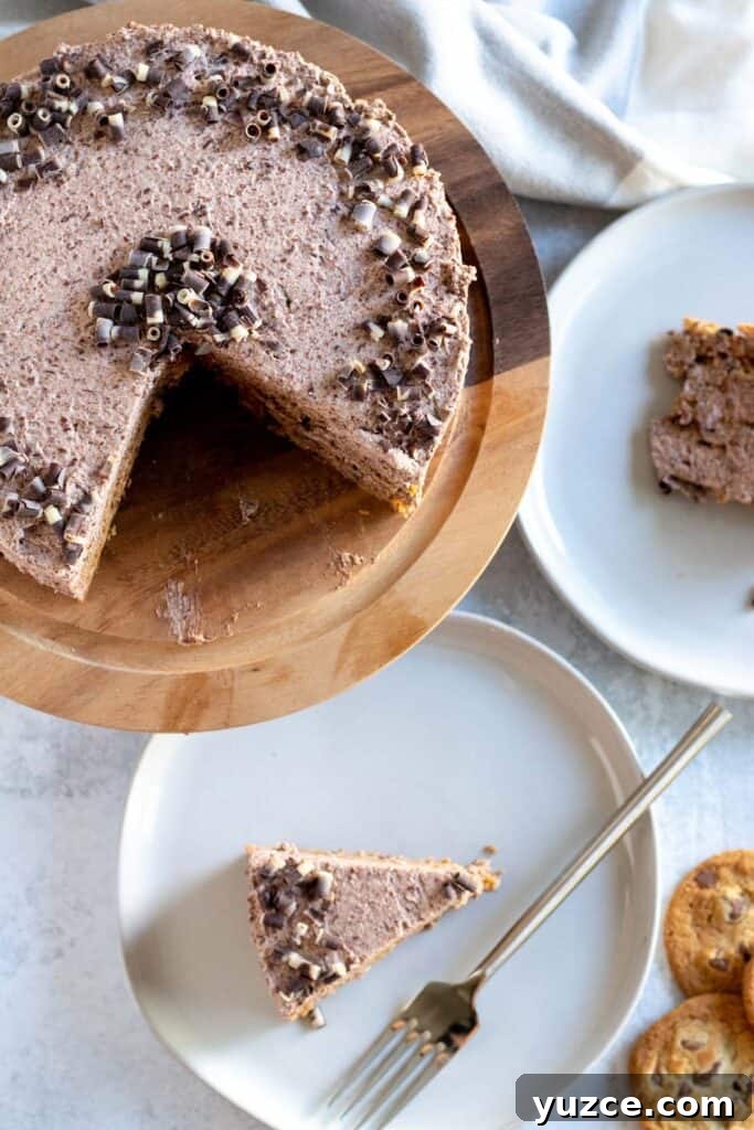 No-Bake Chocolate Icebox Cake Recipe for Creamy Layered Dessert 6 overhead view of cake on wood cake stand with slices on plates