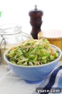 Cucumber and Edamame Salad with Sesame Ginger Dressing 8 A blue bowl filled with creamy pasta and vegetables.
