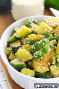 Cucumber and Edamame Salad with Sesame Ginger Dressing 9 A white dish with the asian spicy cucumber salad.