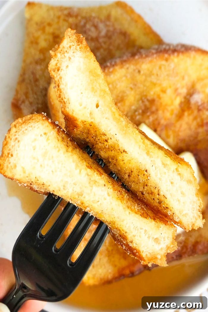 Cinnamon French Toast Recipe: Fluffy Morning Classic 4 Closeup of Homemade French Toast on Black Fork
