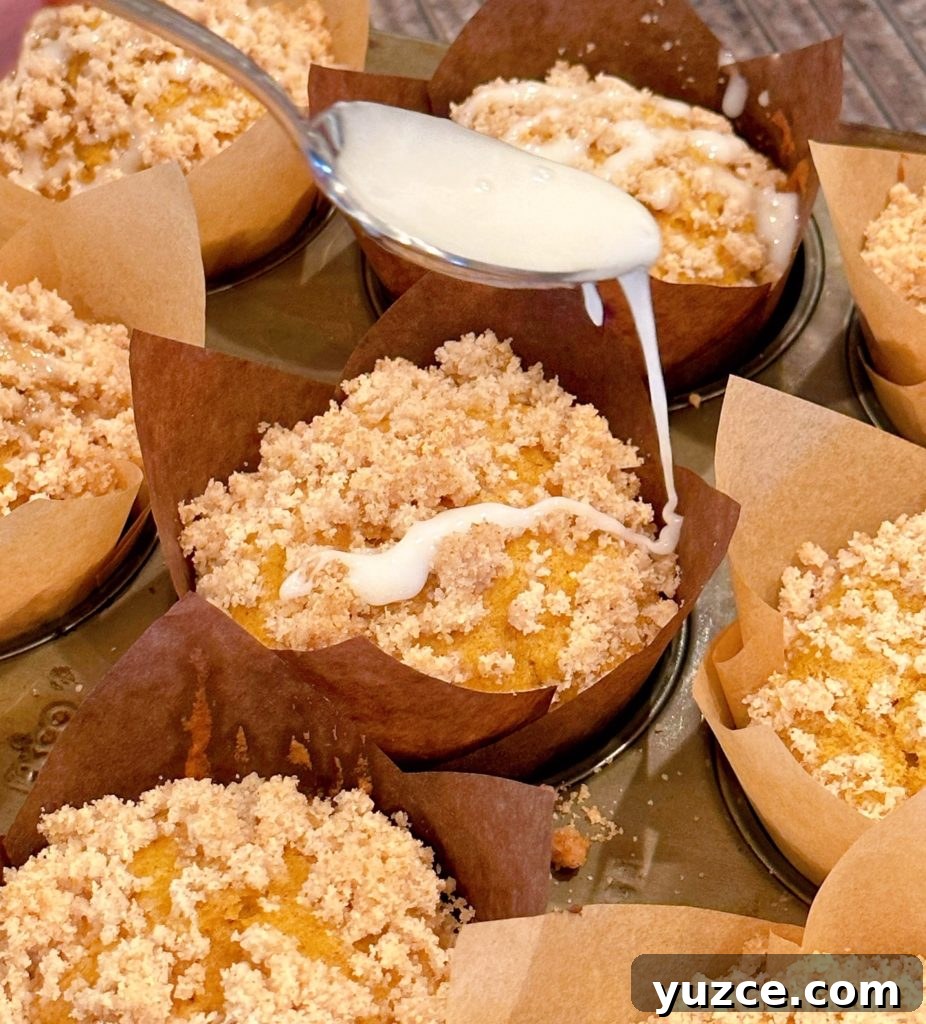 Pumpkin Streusel Muffins with Cinnamon Crumble 11 Drizzling the top of each pumpkin streusel muffin with glaze.