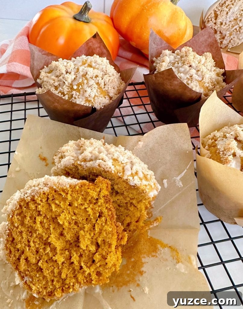 Pumpkin Streusel Muffins with Cinnamon Crumble 13 Pumpkin muffin cut open on a cooling rack.