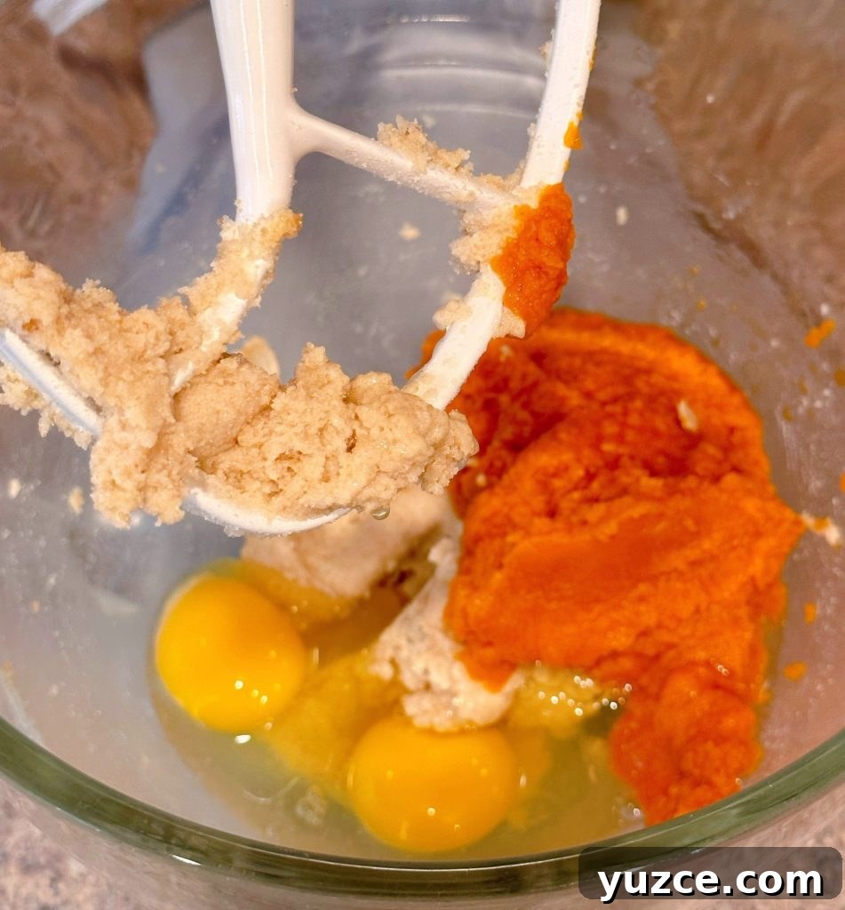 Pumpkin Streusel Muffins with Cinnamon Crumble 5 Batter ingredients in the bowl of a stand mixer.