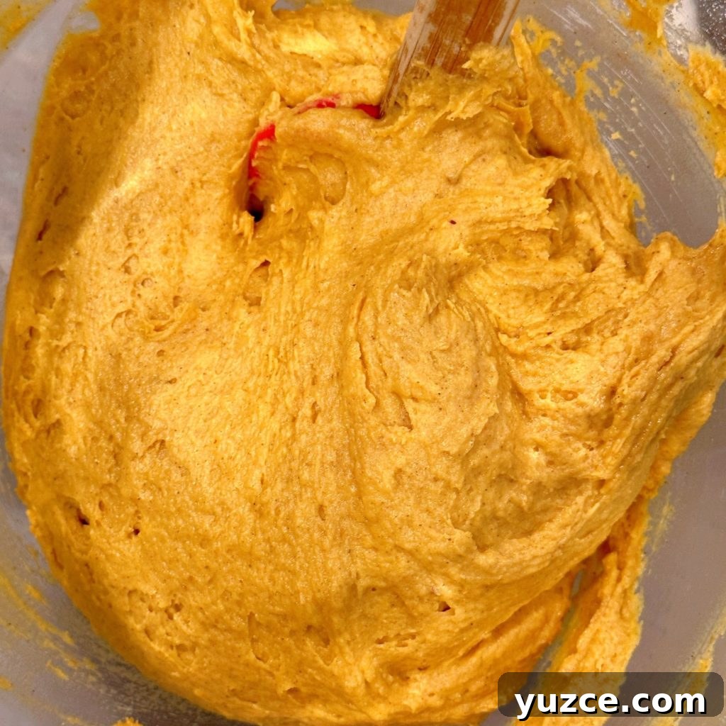 Pumpkin Streusel Muffins with Cinnamon Crumble 6 Pumpkin muffin batter mixed in a stand-mixer bowl.