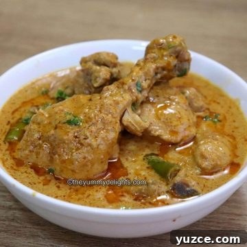 hyderabadi chicken korma served in a white bowl.
