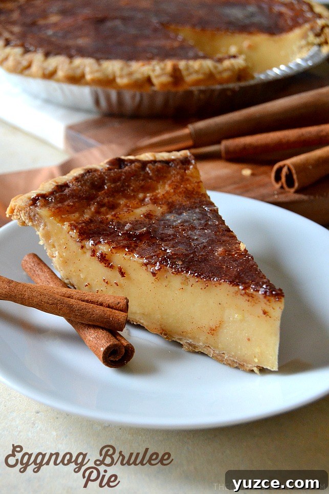 eggnog brulee pie on white plate with cinnamon sticks