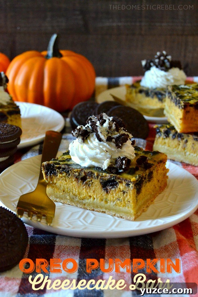 pumpkin oreo cheesecke bars arranged on white plates with forks and pumpkin