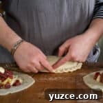 Authentic Cornish Pasty Recipe: Traditional Step-by-Step Guide 22 Womans hands crimping the crust of a traditional Cornish pasty