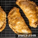Authentic Cornish Pasty Recipe: Traditional Step-by-Step Guide 24 black background with blue cloth and golden Cornish pasty