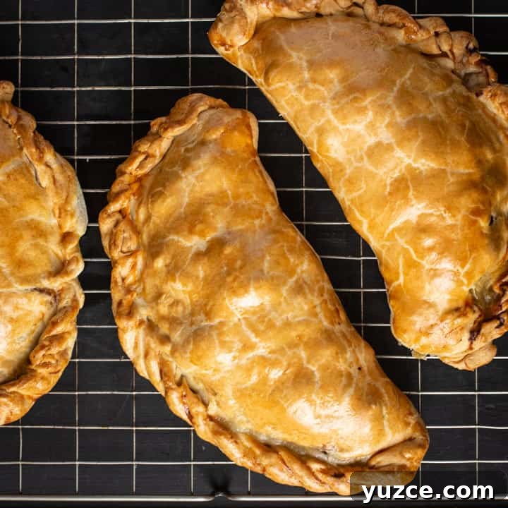Authentic Cornish Pasty Recipe: Traditional Step-by-Step Guide 5 black background with blue cloth and golden Cornish pasty