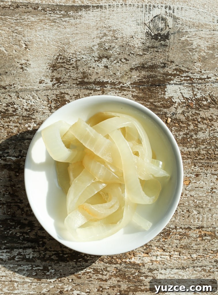 How to Caramelize Onions Perfectly Every Time 5 a white bowl of caramelized onions after 25 minutes