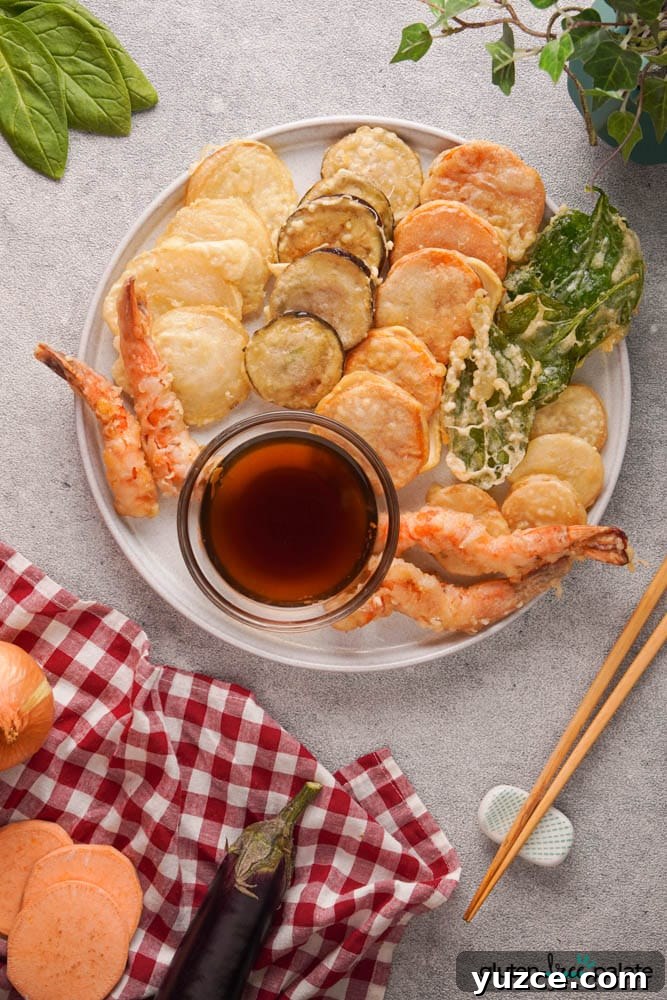 17 Delicious Gluten-Free Shrimp Recipes for Every Meal 19 Gluten-free tempura platter on a white serving plate with a dipping sauce.