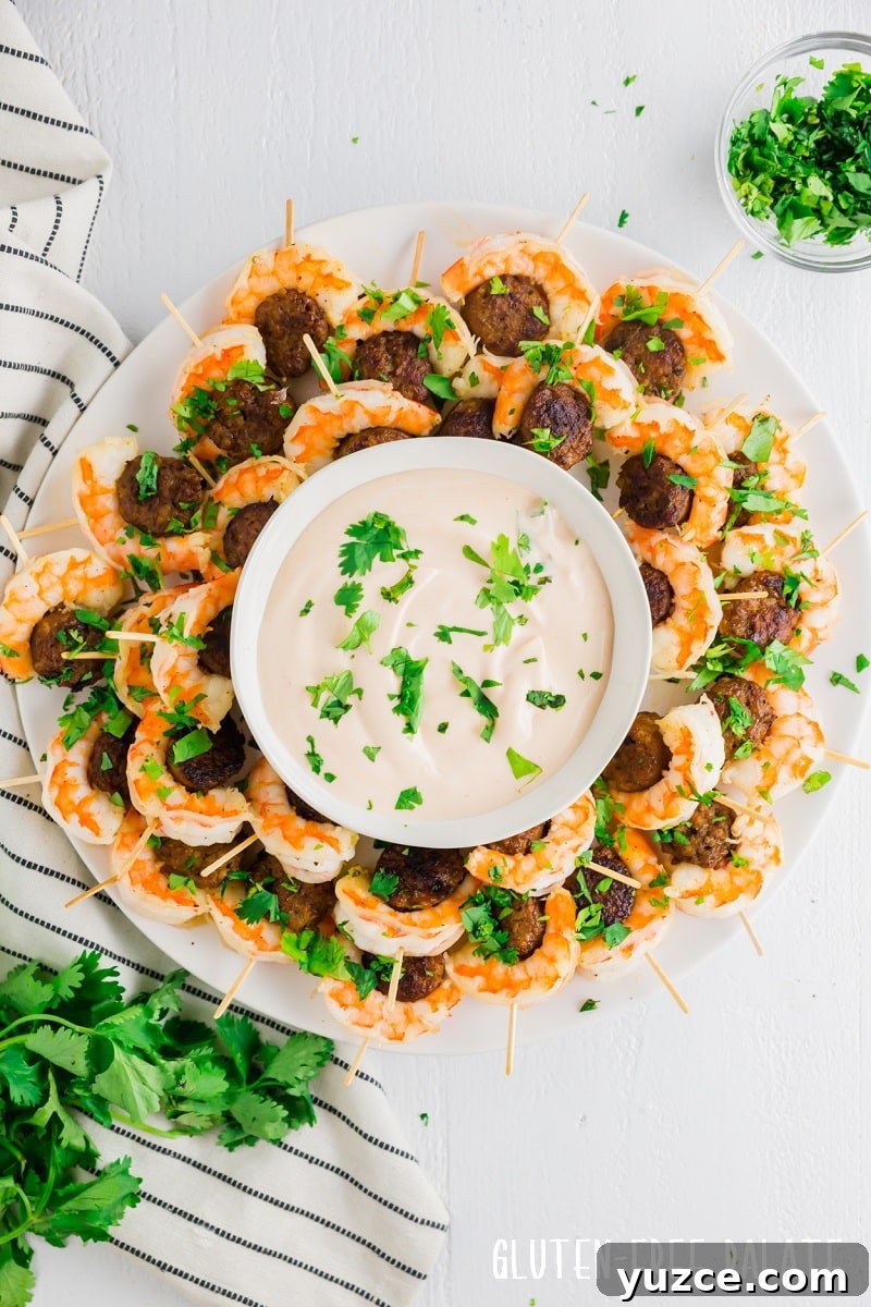 17 Delicious Gluten-Free Shrimp Recipes for Every Meal 3 gluten-free sausage and shrimp on toothpicks around a bowl of dipping sauce