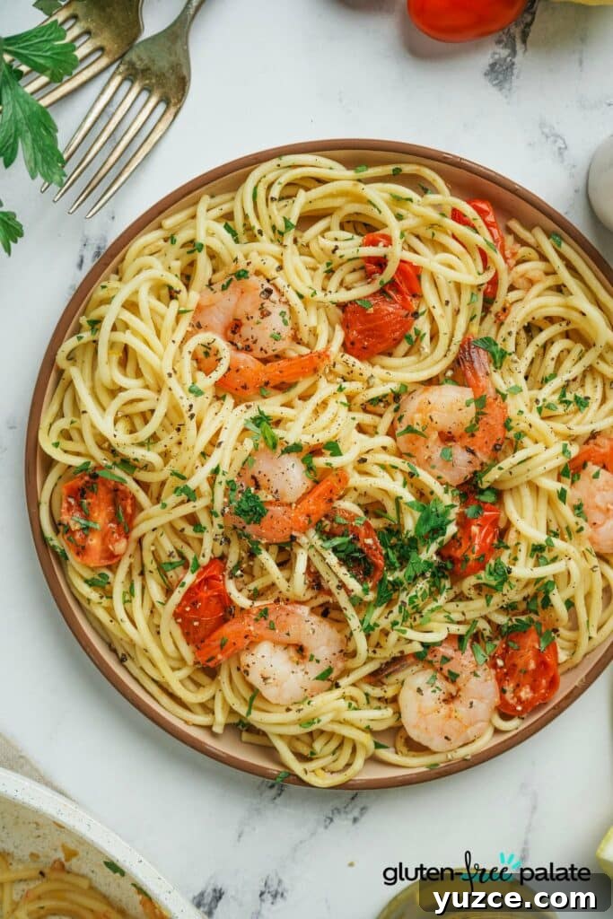 17 Delicious Gluten-Free Shrimp Recipes for Every Meal 6 Gluten-Free Shrimp Scampi in a beige bowl on a counter.