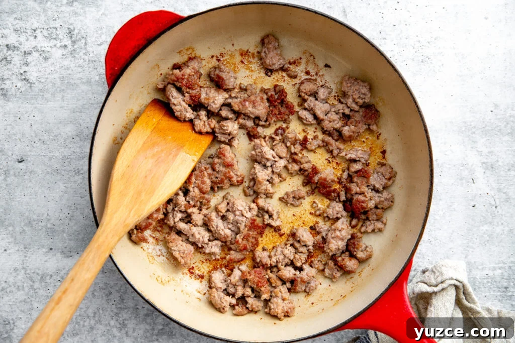 Spicy Peanut Pork Noodles (Gluten-Free, Ready in Minutes) 8 Process shot showing browned ground pork in a skillet.