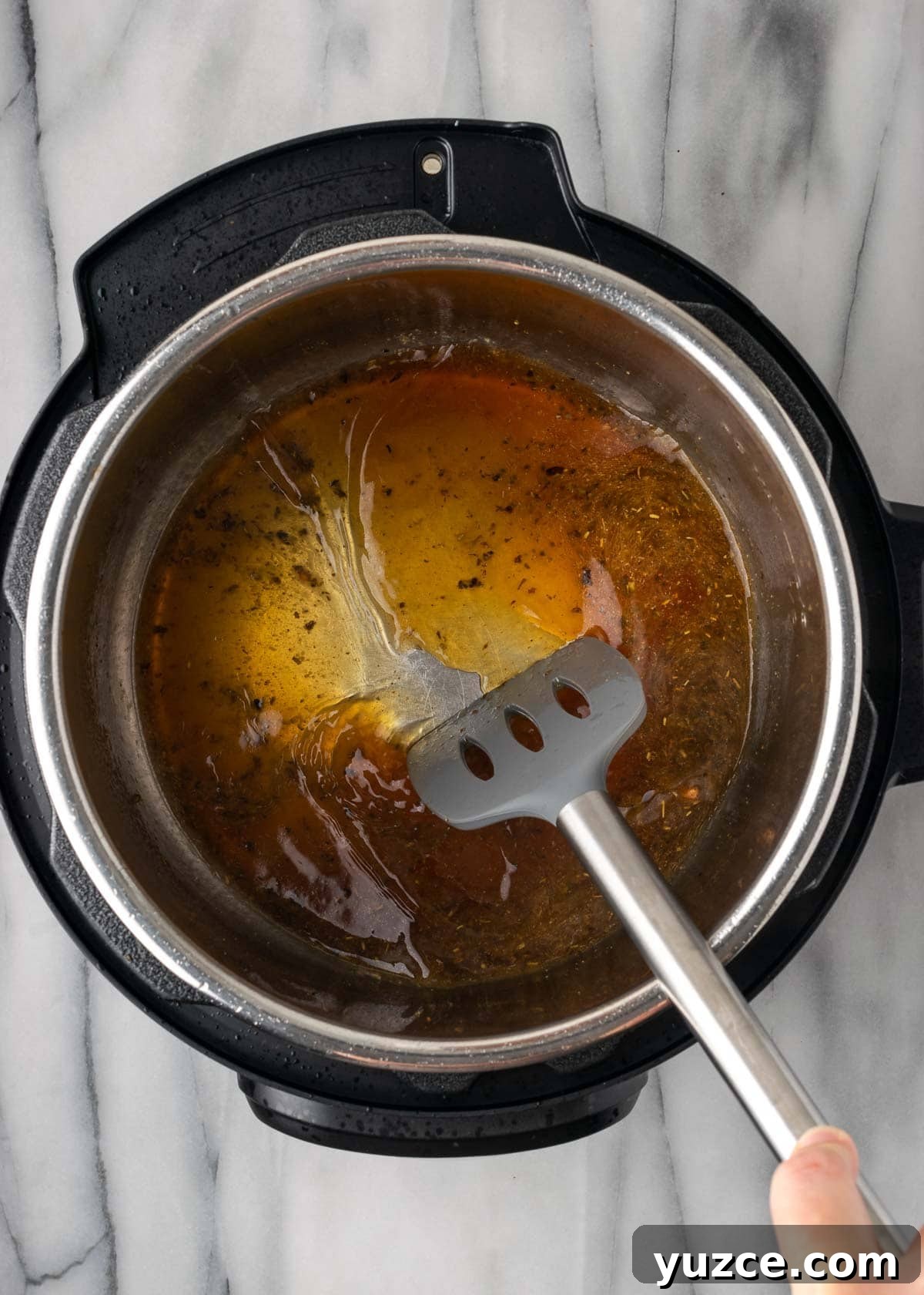 Juicy Instant Pot Chicken Breasts in 15 Minutes 7 deglaze pot with spatula