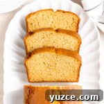 Classic French Yogurt Cake (Gâteau au Yaourt) Recipe 10 Stack of 3 slices of cake seen from above on an oval white plate.