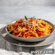 Spaghetti all’Arrabbiata Recipe: Spicy Tomato Pasta Guide 12 Spaghetti arrabiata in a grey bowl on a white napkin.