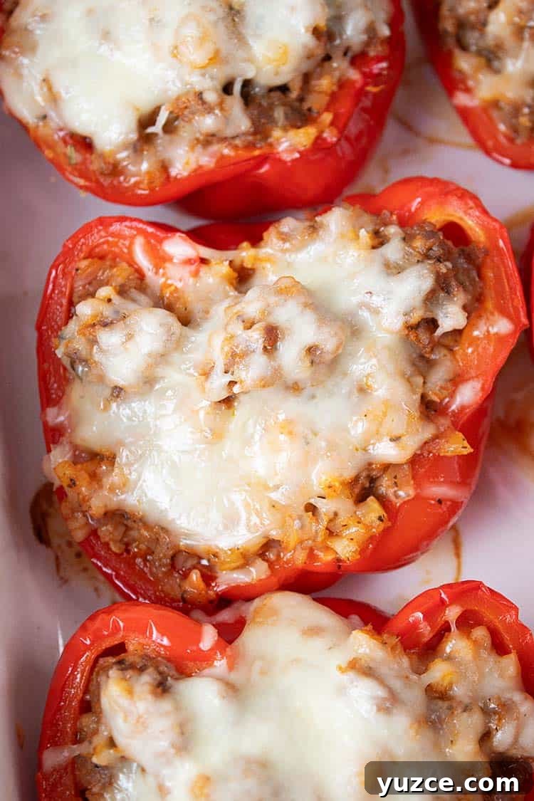 overhead view of keto Italian sausage stuffed peppers on a white serving dish