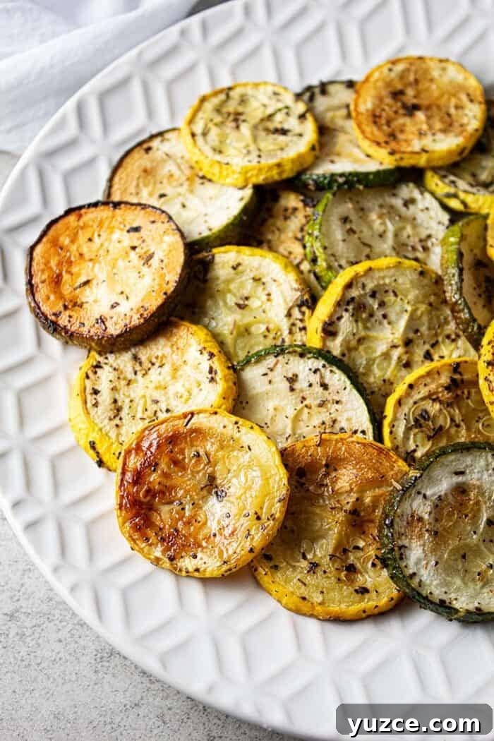 overhead view of oven baked roasted zucchini and squash on a white serving dish