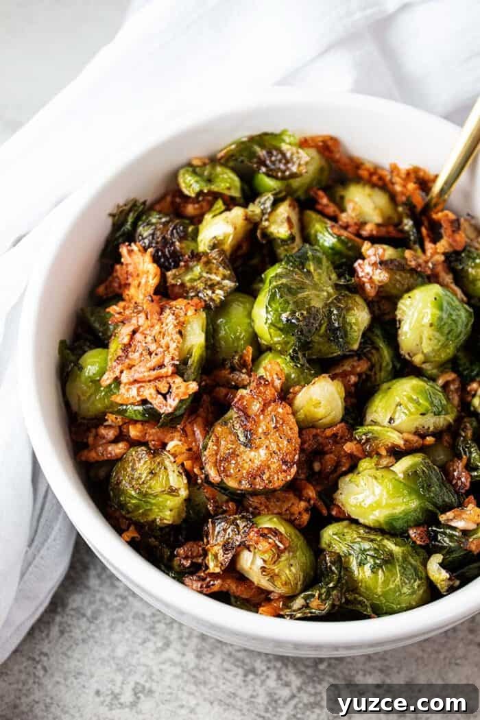 overhead view of keto oven roasted brussel sprouts in white serving bowl