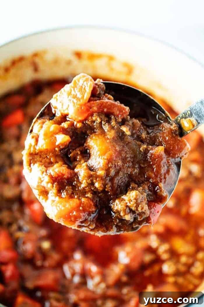 ladle with big scoop of keto chili over pot