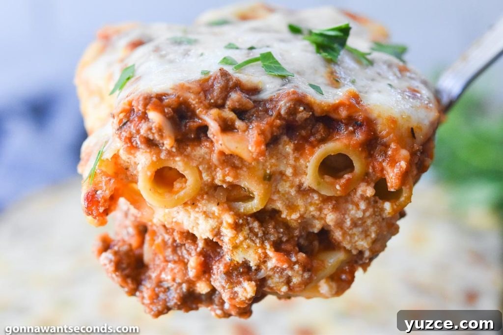 Tour the flavors of Italy with a ziti pasta recipe featuring plenty of creamy melted cheese, perfectly cooked ziti pasta and lots of fragrant herbs. #ZitiPasta #ZitiPastaRecipes A scoop of Baked ziti with ricotta, close up