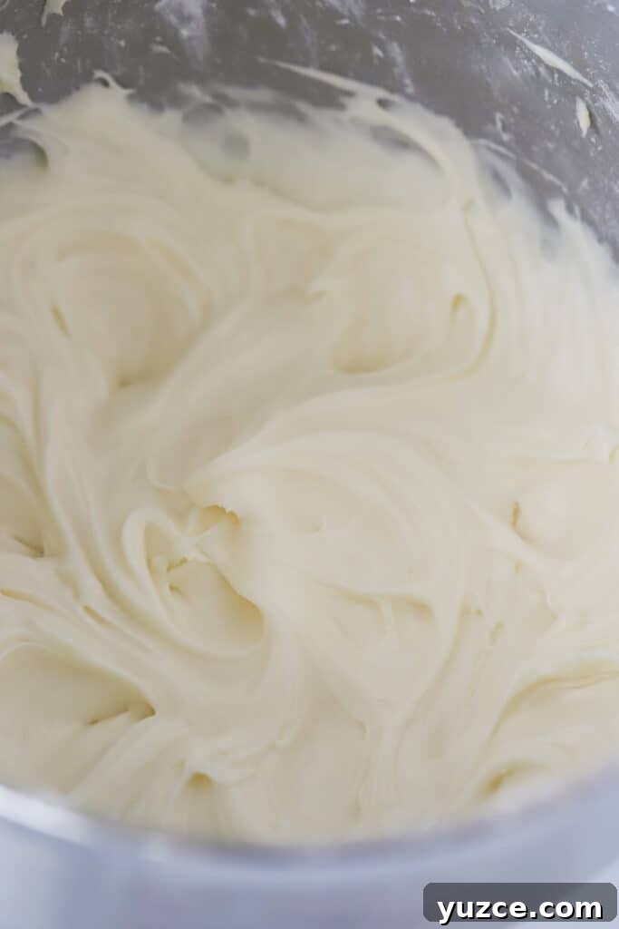 Whipped cream cheese frosting in a mixing bowl. 