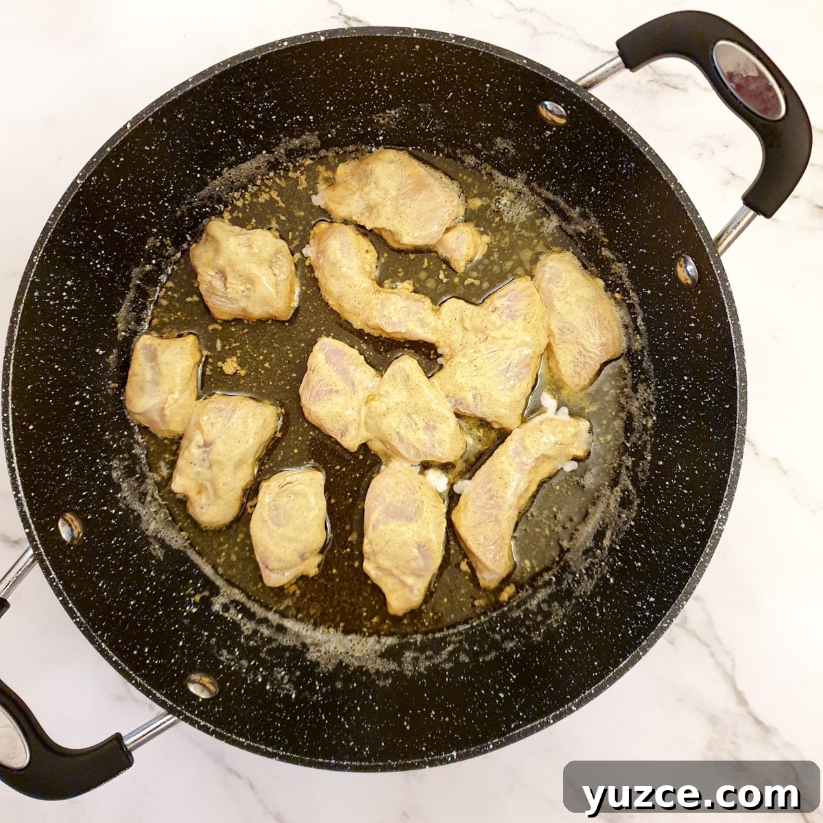Creamy Murgh Makhani (Authentic Butter Chicken Recipe) 7 Pieces of chicken being fried in a frying pan.
