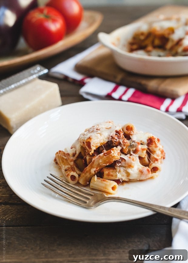 A serving of Baked Ziti with Roasted Eggplant on a white plate.