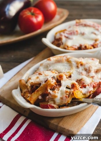 Baked Ziti with Roasted Eggplant and Peppers in a white baking dish.