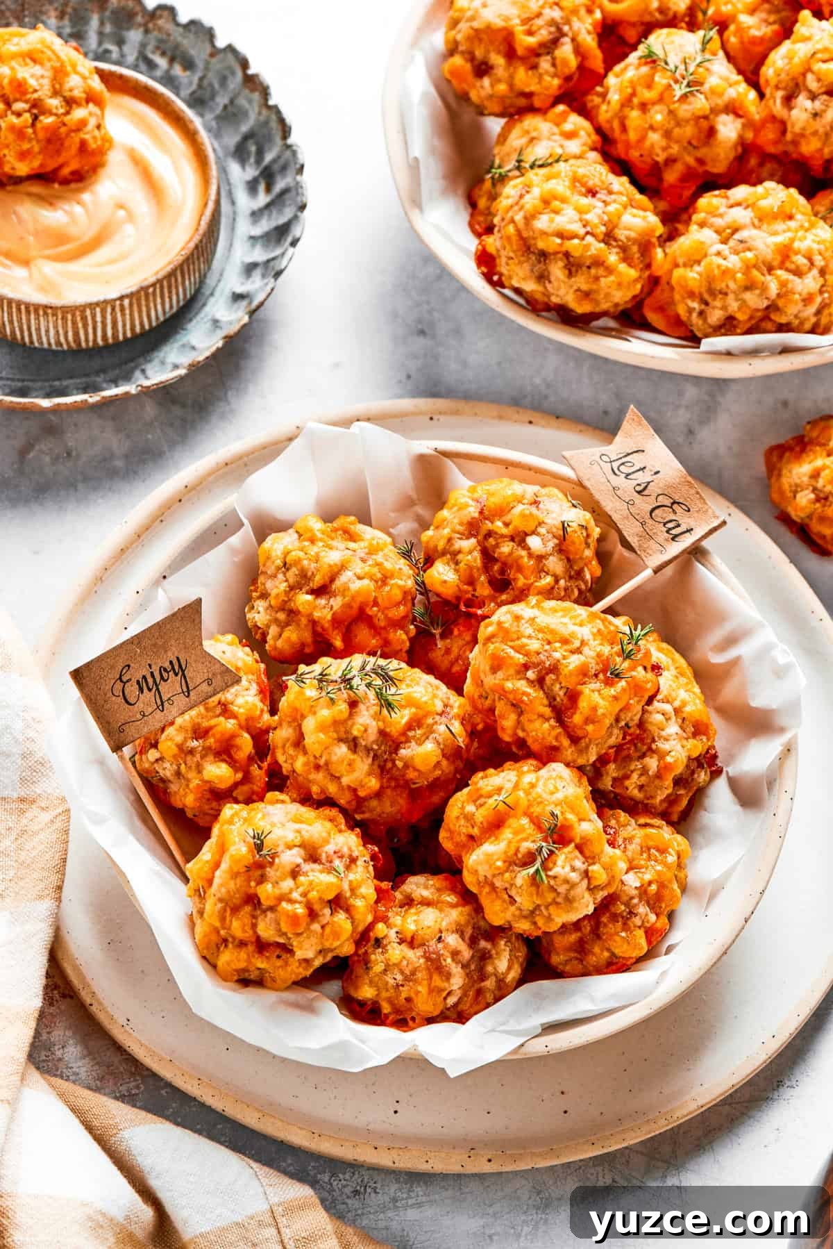 Two bowls filled with baked sausage balls.