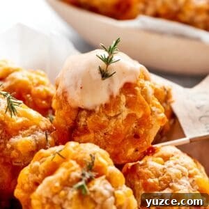Dipping sauce tops a sausage ball.