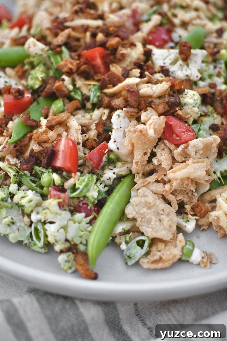 Crisp Snap Pea Salad with Lemon-Herb Vinaigrette 2 Snap Pea Salad on a platter topped with bacon bits and crispy onions ready to eat.