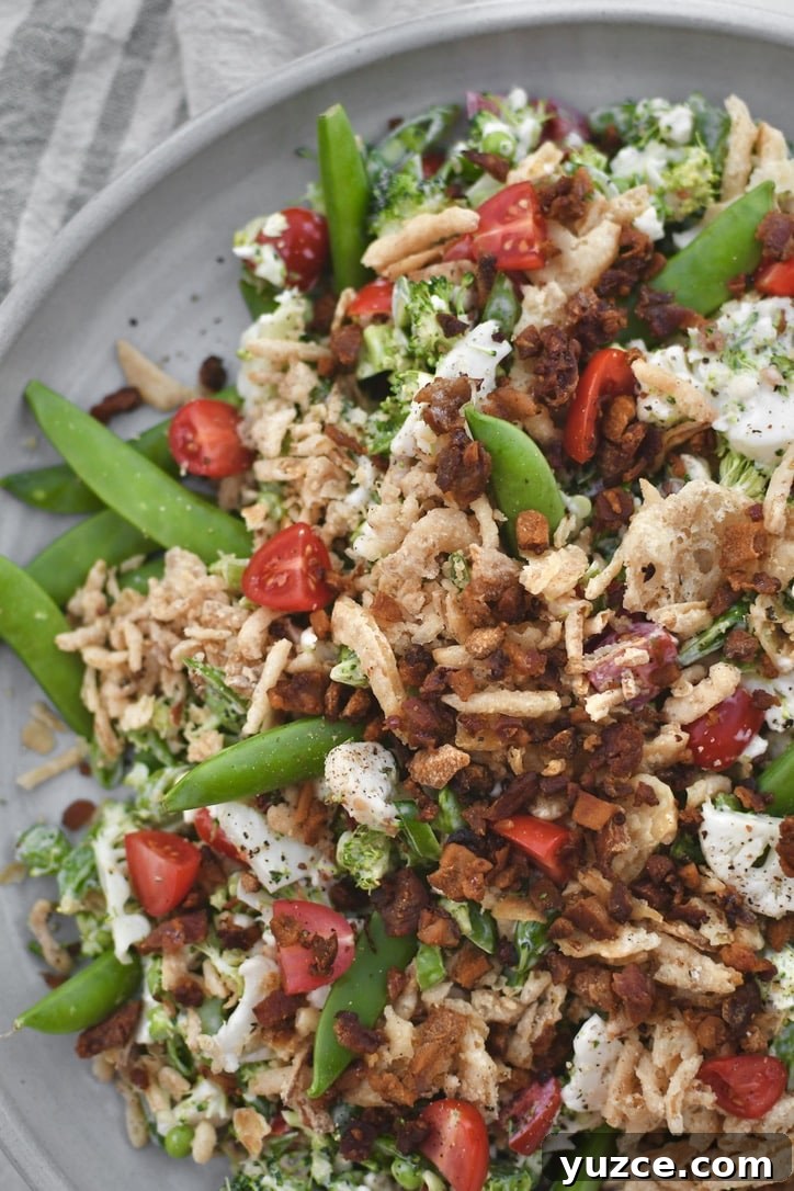 Crisp Snap Pea Salad with Lemon-Herb Vinaigrette 8 Snap Pea Salad on a platter topped with bacon bits and crispy onions ready to eat.