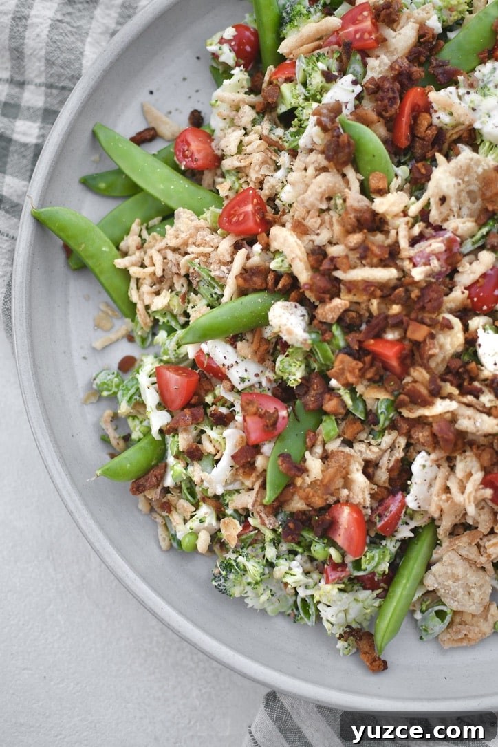 Crisp Snap Pea Salad with Lemon-Herb Vinaigrette 9 Snap Pea Salad on a platter topped with bacon bits and crispy onions ready to eat.