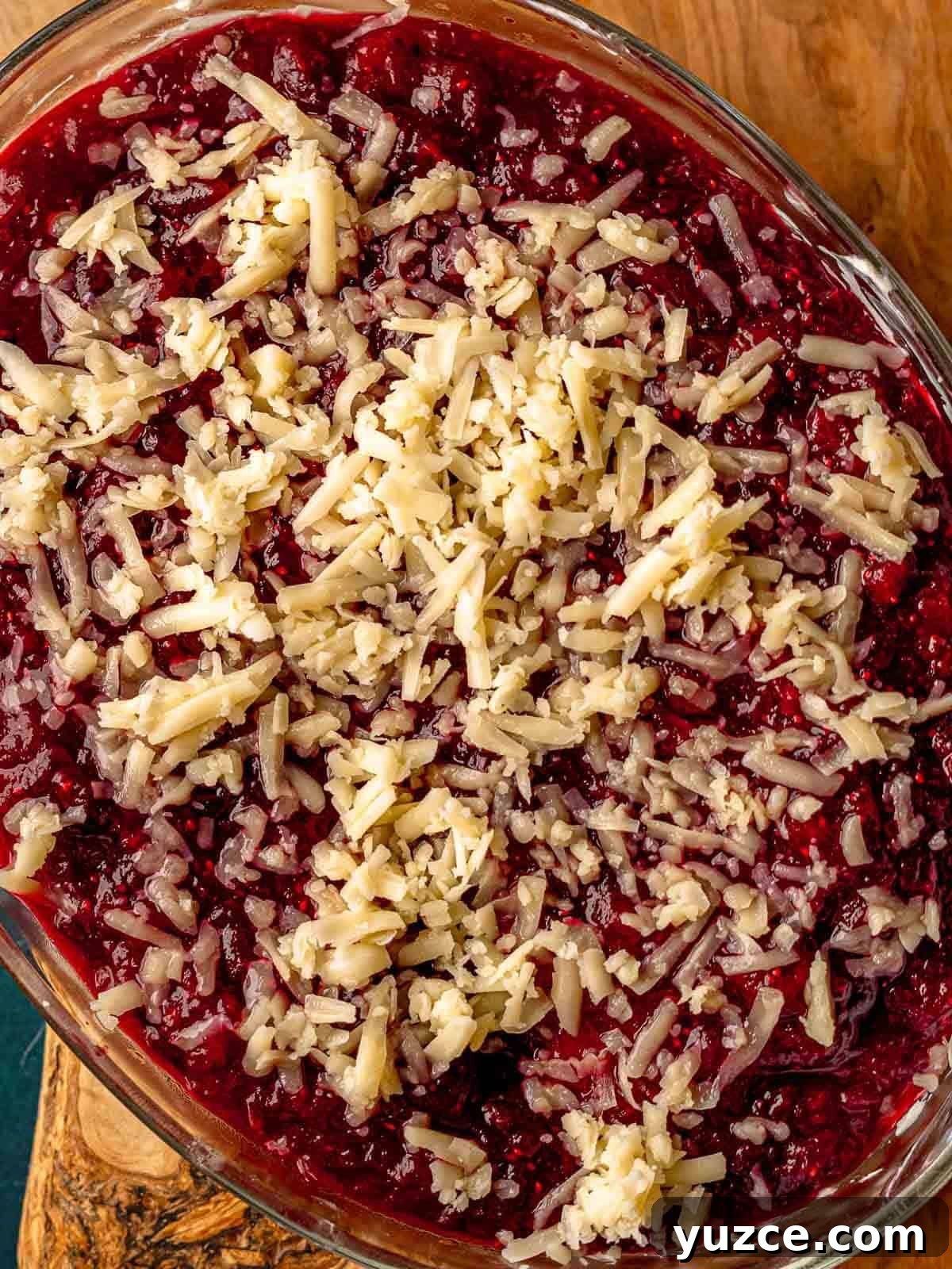 Cranberry Jalapeño Cream Cheese Dip Recipe for Holiday Parties 9 Shredded cheese on top of cranberry sauce.