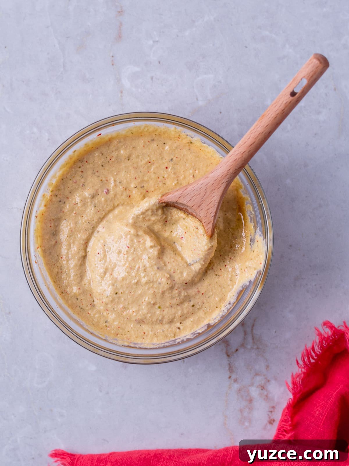 Spicy Kimchi Mayo Recipe for sandwiches, dips, and more 7 small bowl containing kimchi mayo and a spoon