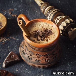 Oaxacan Hot Chocolate (Xocolatl): Authentic Mexican Recipe 10 Overhead shot of Oaxacan hot chocolate in a clay mug with cinnamon stick.