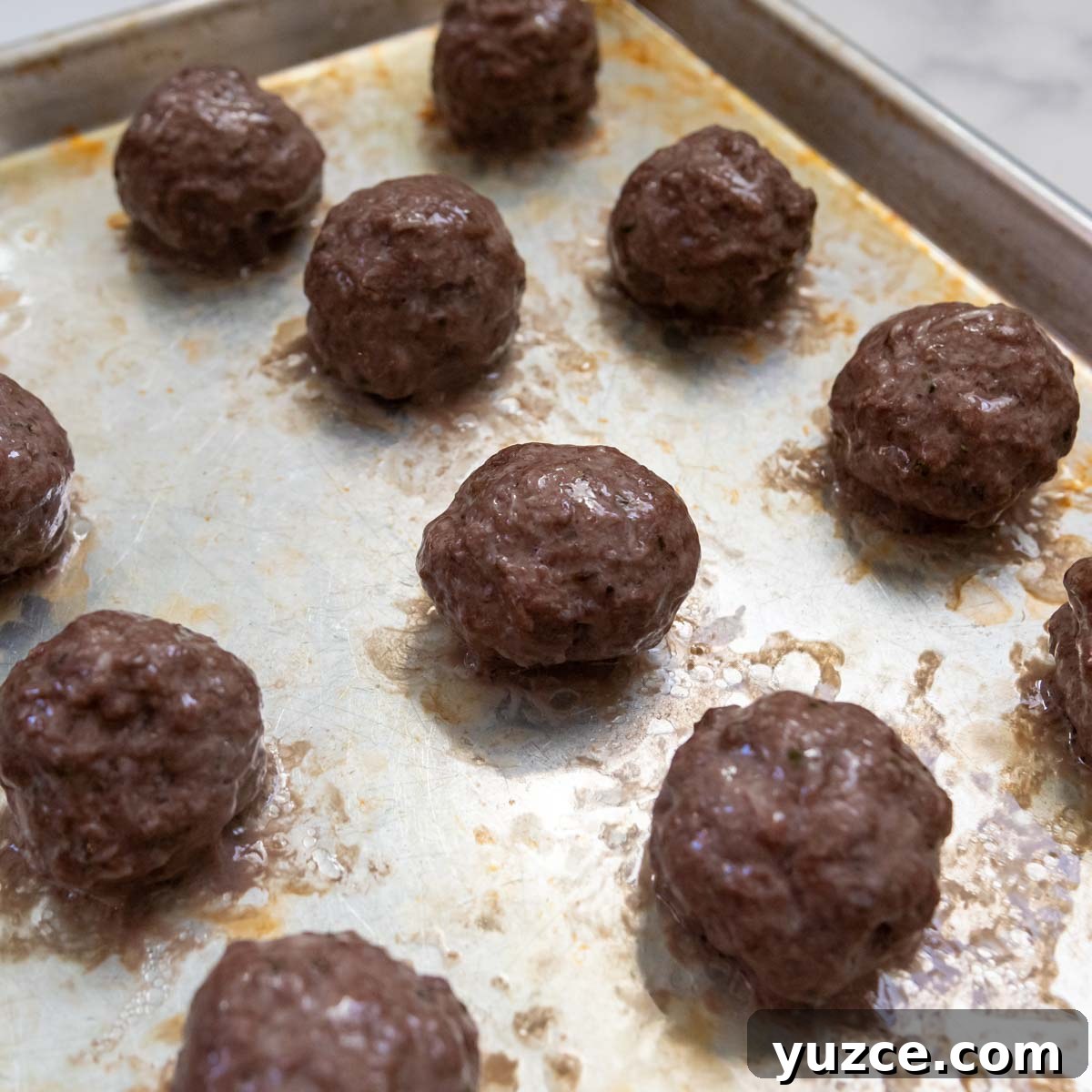 Gluten-Free All-Beef Meatballs Without Breadcrumbs 4 meatballs after browning in an oven.