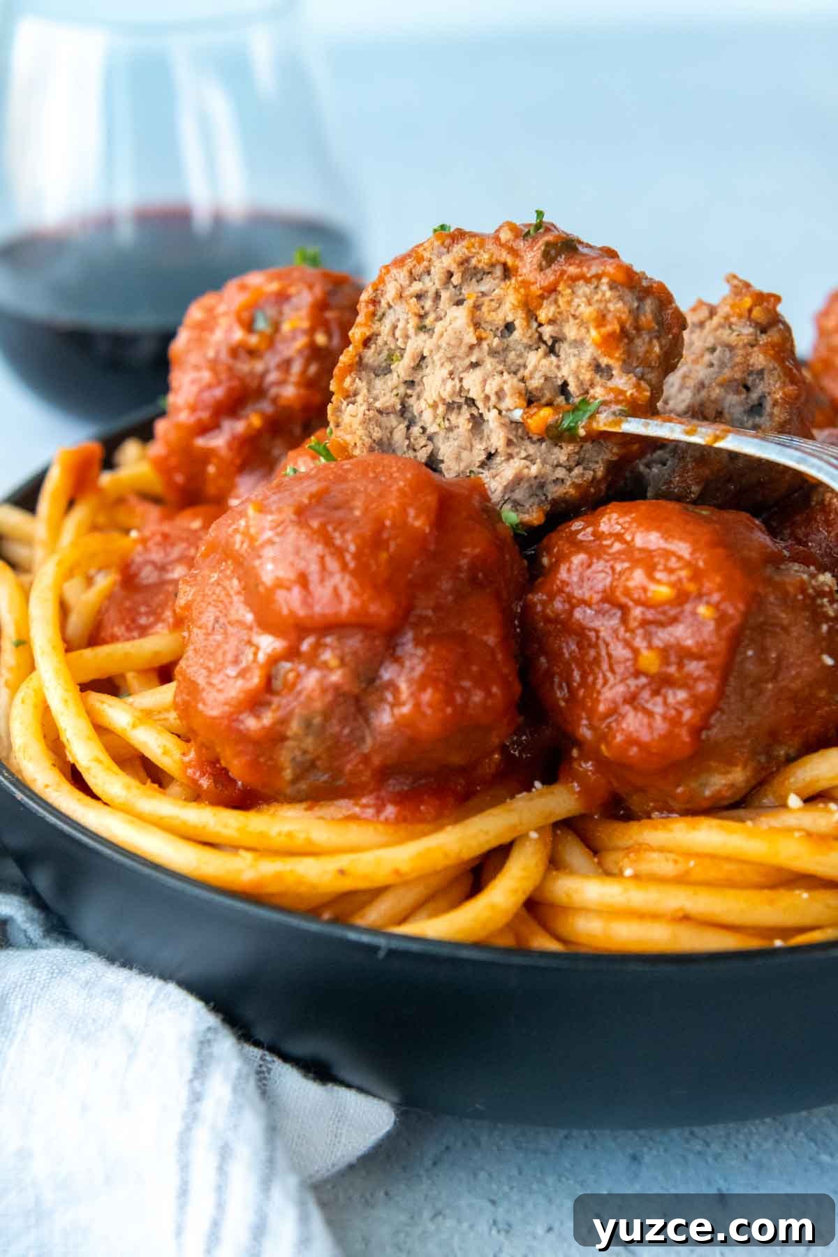 Gluten-Free All-Beef Meatballs Without Breadcrumbs 6 a meatball speared with a fork that has been cup open.