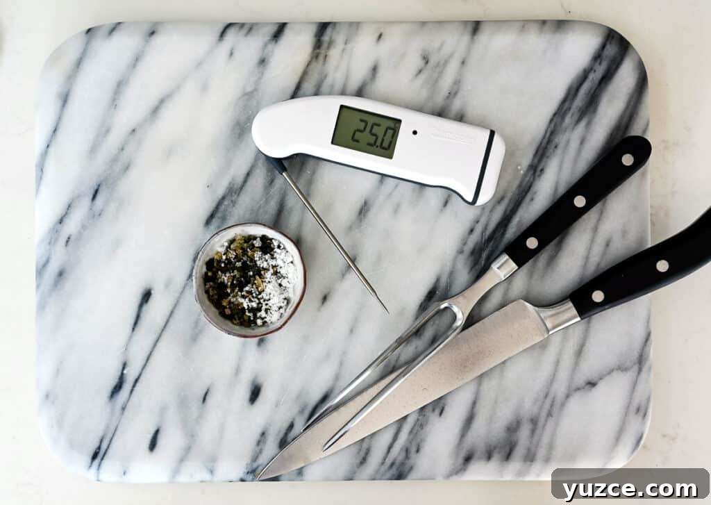 Perfect Reverse Sear Steak Technique for Tender, Crispy Results 5 Digital thermometer, carving set and seasoning on a marble board