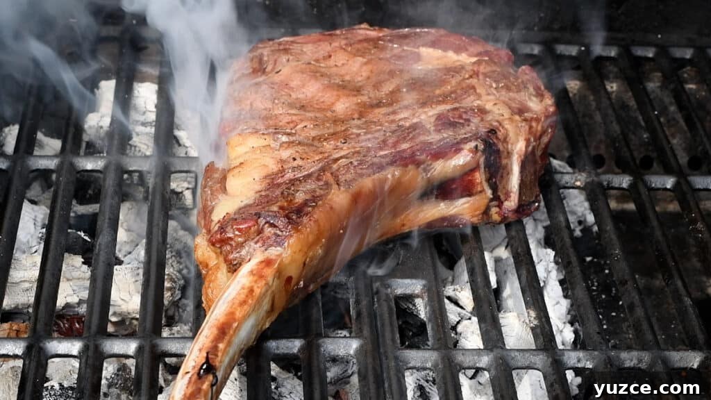 Perfect Reverse Sear Steak Technique for Tender, Crispy Results 9 steak smoking on a grill
