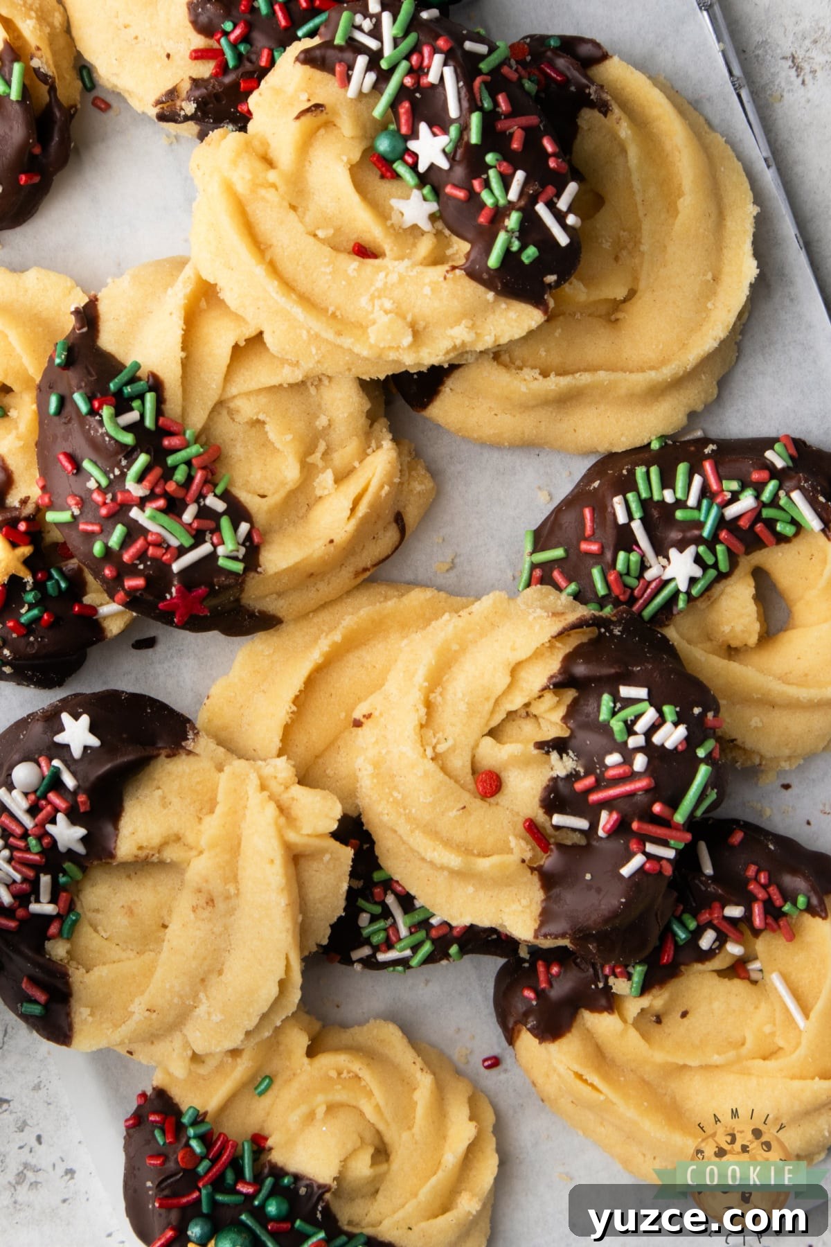 Classic holiday butter cookies made with buttery cookie dough and covered in chocolate & sprinkles. Incredible shortbread cookie with a delicate texture and fantastic flavor!