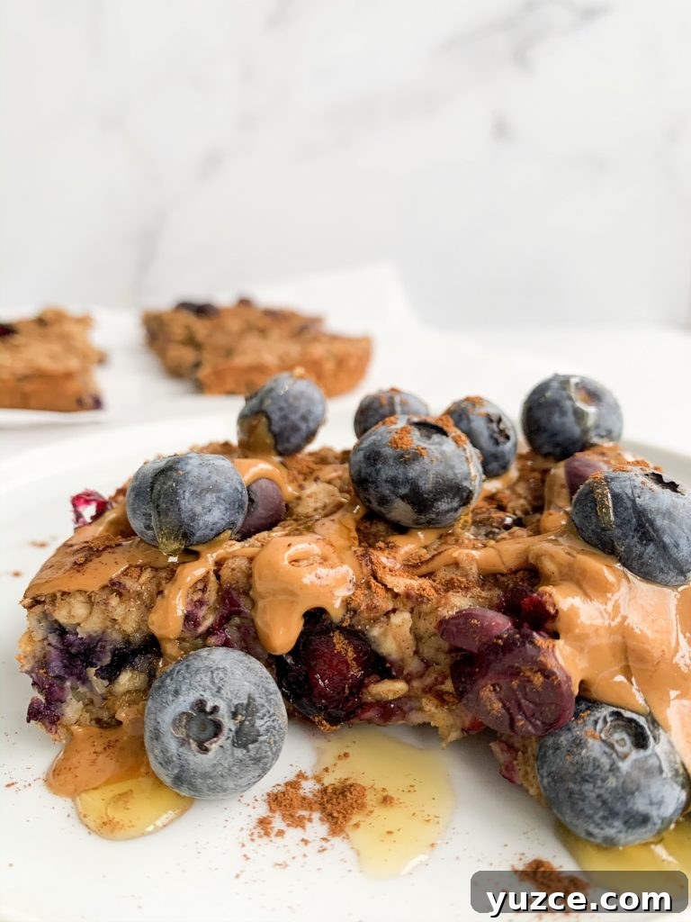 Peanut Butter Banana Berry Baked Oats — Protein-Packed Breakfast 4 peanut butter banana baked oatmeal with blueberries and extra peanut butter on top
