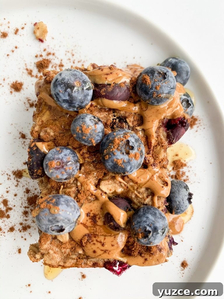 Peanut Butter Banana Berry Baked Oats — Protein-Packed Breakfast 5 slice of baked oatmeal on a white plate