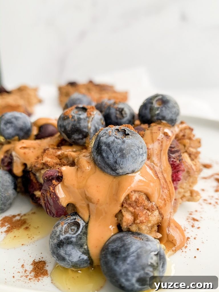 Peanut Butter Banana Berry Baked Oats — Protein-Packed Breakfast 9 close up of a slice of peanut butter banana berry baked oatmeal