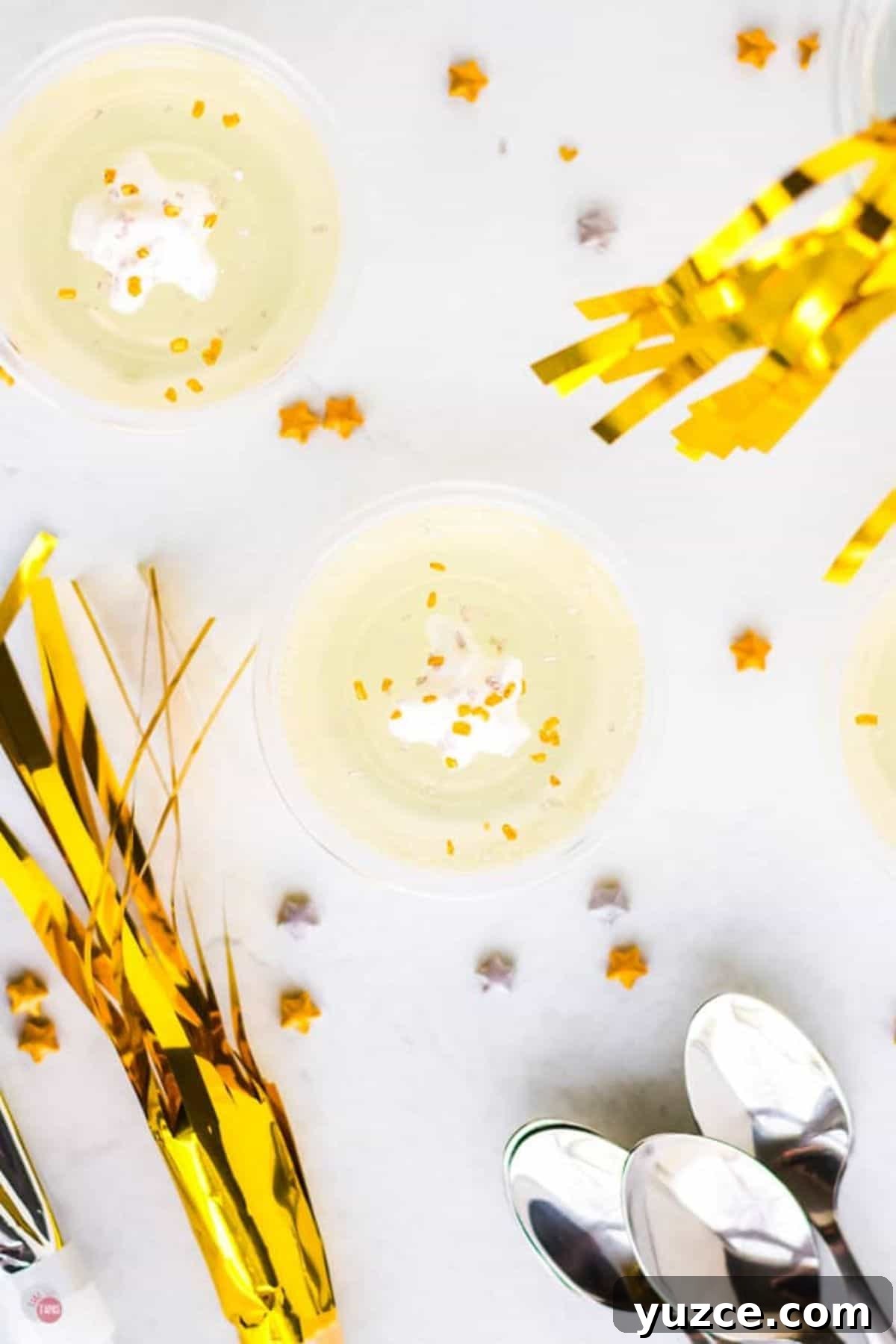 Champagne Jello Shots Recipe: Fizzy Party Cocktail Bites 8 overhead show of jello in a cup with sparklers